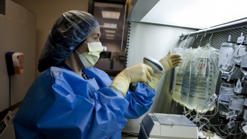 Nurse checks IV medications.